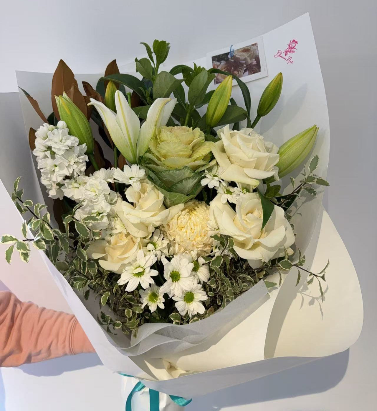 Bouquet of white flowers with green leaves