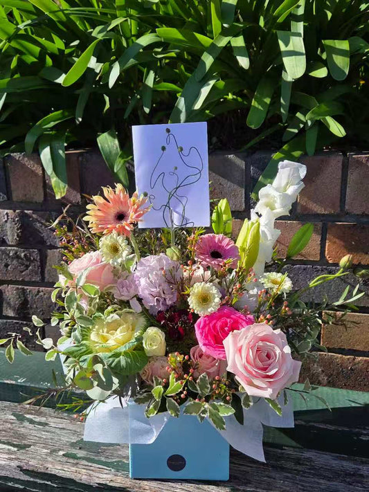 Box of flowers arranged beautifully using the best seasonal flowers.