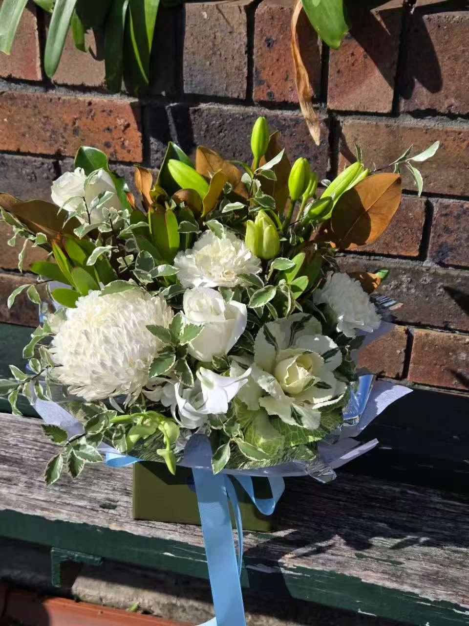 Bouquet of white flowers with green leaves.